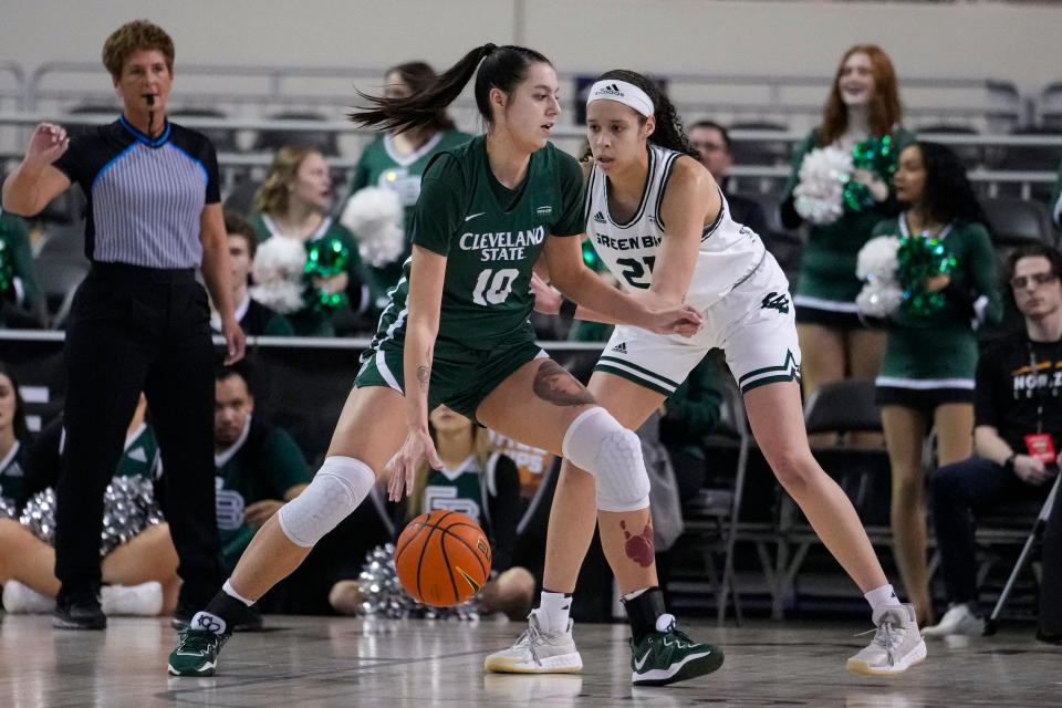 Cleveland State forward Jordana Reisma (10) drives on Green Bay forward Jasmine Kondrakiewicz (21) during the first half of an NCAA college basketball game in the Horizon League women's tournament championship in Indianapolis, Tuesday, March 7, 2023. (AP Photo/Michael Conroy)