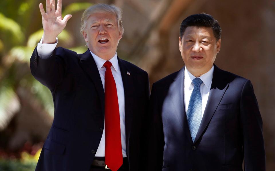 US. President Donald Trump, left, and Chinese President Xi Jinping - Credit: AP