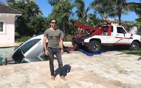  Guy Gentile poolside in the Bahamas as workers pull hit car out of the water - Credit: Guy Gentile