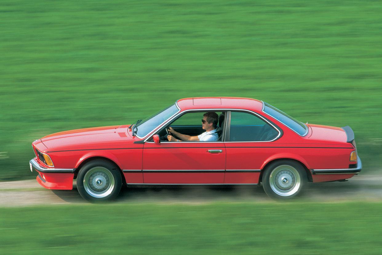 a person driving a red car