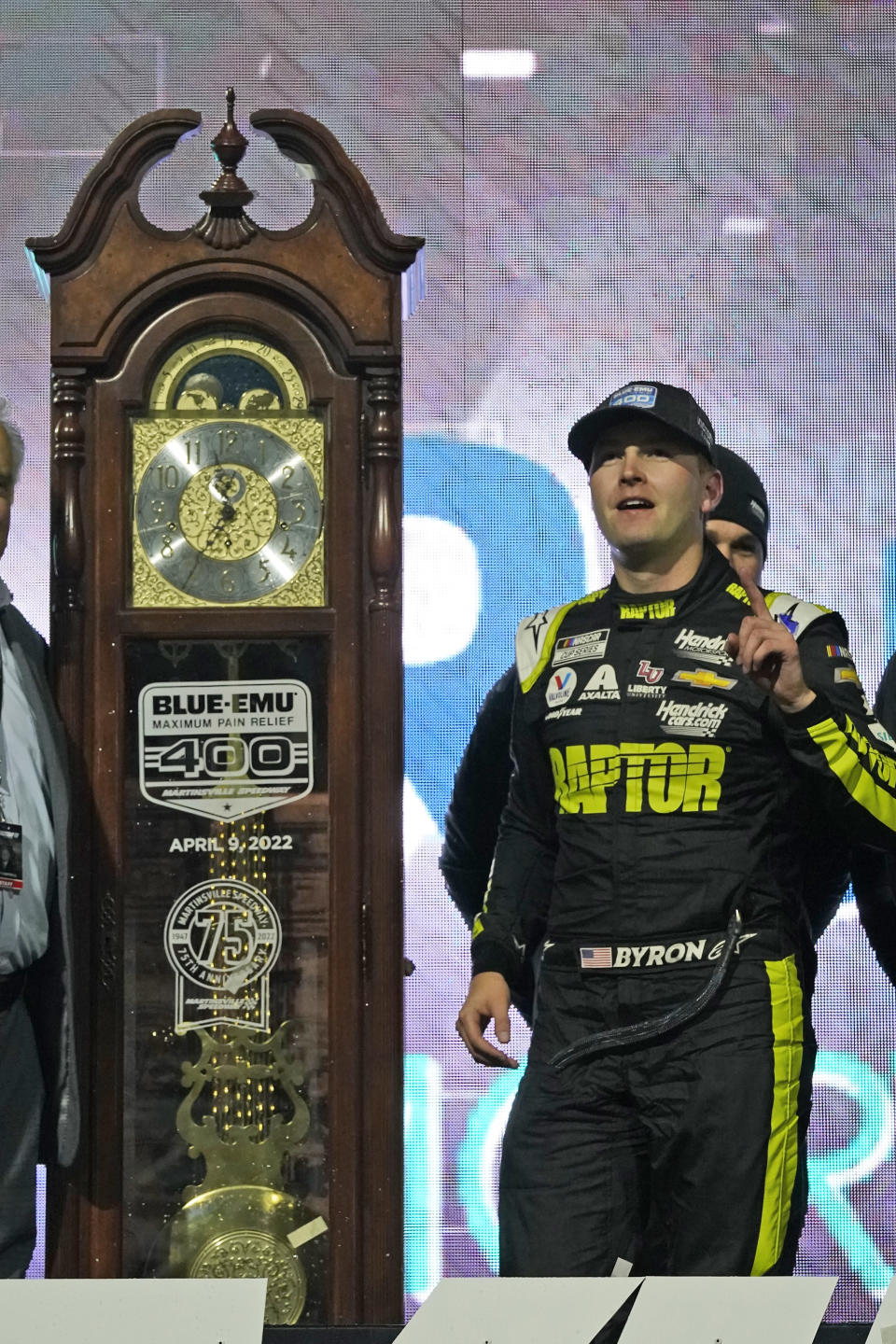 William Byron stand next to the trophy in Victory Lane after winning the NASCAR Cup Series auto race at Martinsville Speedway on Saturday, April 9, 2022, in Martinsville, Va. (AP Photo/Steve Helber)