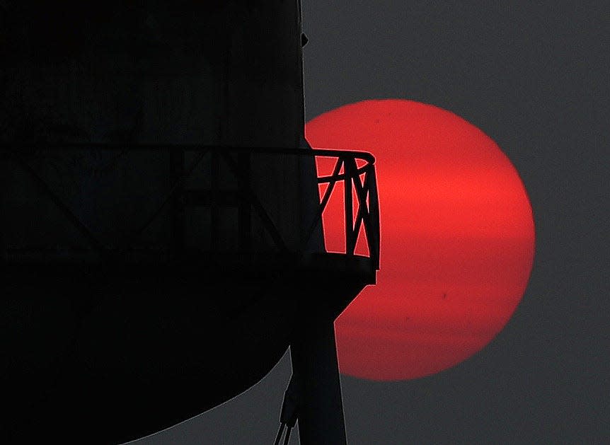 The sun sets behind a water tower on Route 22 in Brewster recently. Smoke from wildfires in Canada are making for some amazing sunsets.