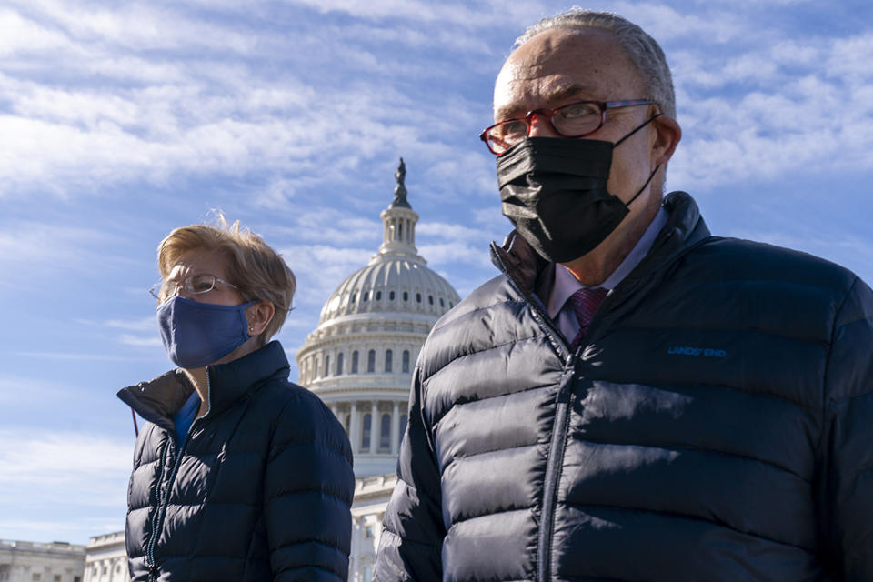 Senate Majority Leader Sen. Chuck Schumer of N.Y., and Sen. Elizabeth Warren, D-Mass., arrive for a news conference on Capitol Hill in Washington, Thursday, Feb. 4, 2021, about plans to reintroduce a resolution to call on President Biden to take executive action to cancel up to $50,000 in debt for federal student loan borrowers. (AP Photo/Andrew Harnik)