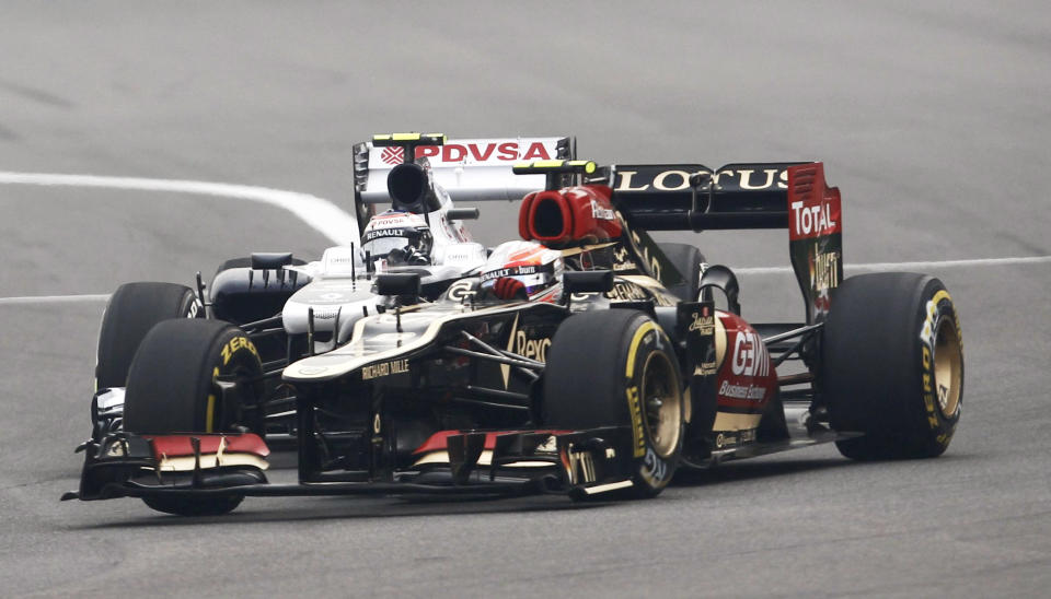 Lotus F1 Formula One driver Grosjean drives ahead of Williams Formula One driver Bottas during the Indian F1 Grand Prix at the Buddh International Circuit in Greater Noida