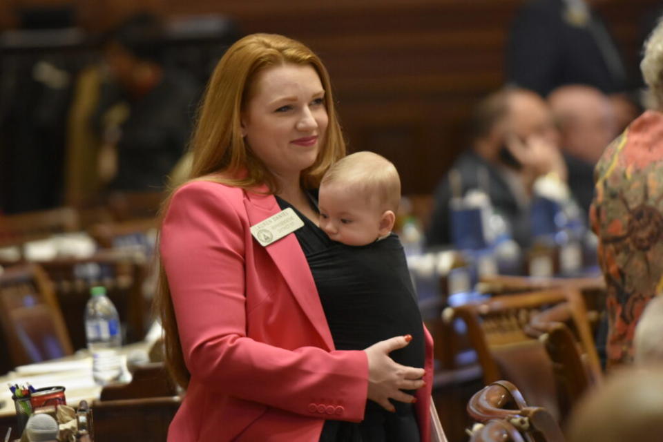  Georgia Rep. Lauren Daniel on the House floor, holding her son Zane. (Ross Williams/Georgia Recorder)