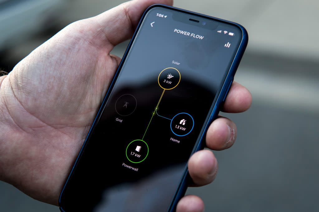 An app shows the power flow of a home equipped with a Tesla Inc. Solar Roof and Powerwall in San Ramon, California, U.S., on Saturday, Feb. 8, 2020. Tesla Chief Executive Officer Elon Musk is pushing the Solar Roof and batteries as essential components of the company's drive to reduce fossil fuel use. Photographer: David Paul Morris/Bloomberg via Getty Images