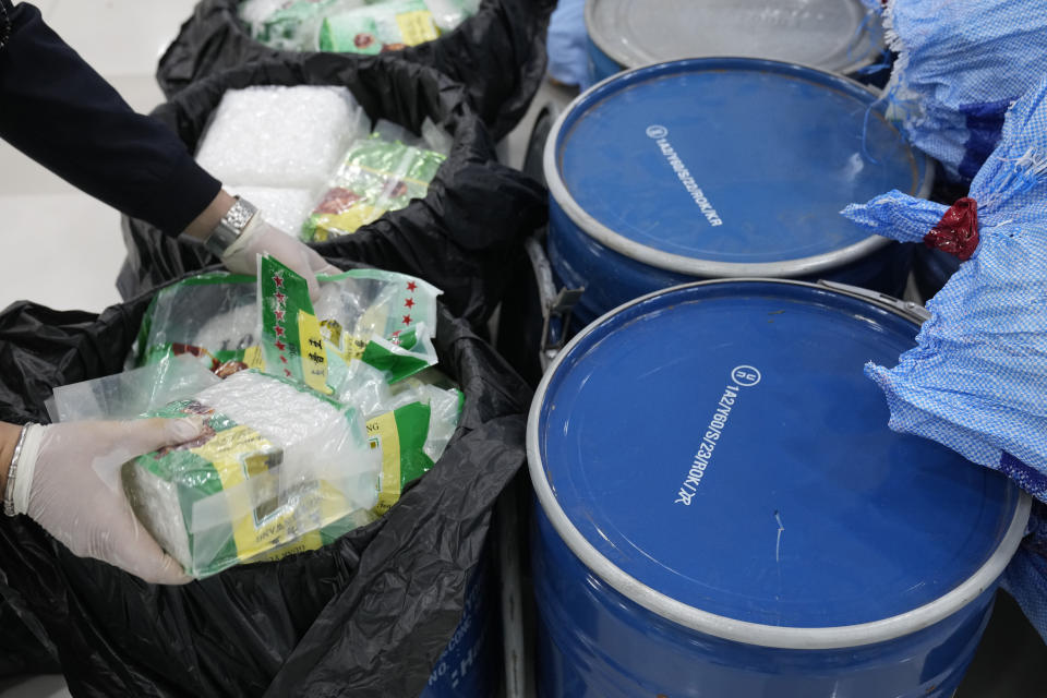 FILE - A Thai officer displays seized crystal methamphetamine which were disguised as packages of tea during a news conference in Bangkok, Thailand, on June 1, 2023. The U.N. drug fighting agency says East and Southeast Asia are awash in record amounts of methamphetamine and other synthetic drugs, originating largely from the cross-border area known as the Golden Triangle, historically known for growing opium and hosting many of the labs that converted it to heroin. (AP Photo/Sakchai Lalit)