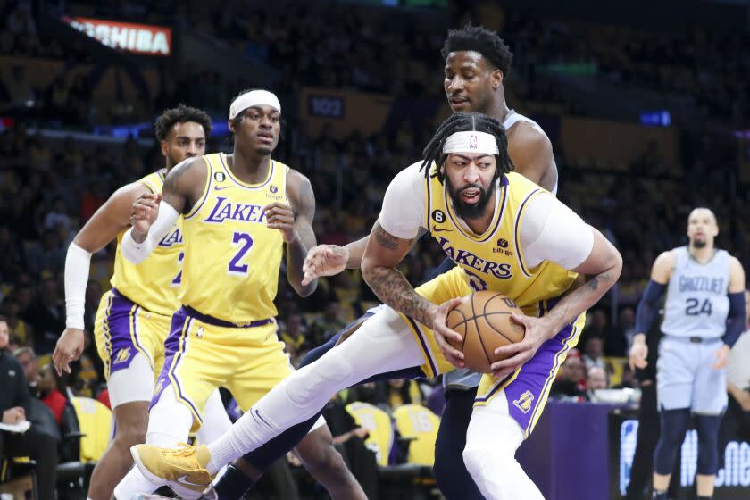 LOS ANGELES, CALIF.  - MAR.  7, 2023. Los Angeles Lakers center Anthony Davis pulls down a rebound during the first half against the Memphis Grizzlies in an NBA game at Crypto.com Arena in Los Angeles on Tuesday, Mar.  7, 2023. (Luis Sinco/Los Angeles Times)