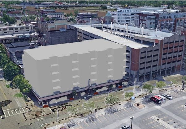A rendering of the building at 216-222 Cherry St. with several floors of apartments added atop first floor commercial spaces that include Bosse's News & Tobacco. Building owner Peter Nugent has said the project would add at least 39 apartments in downtown Green Bay.