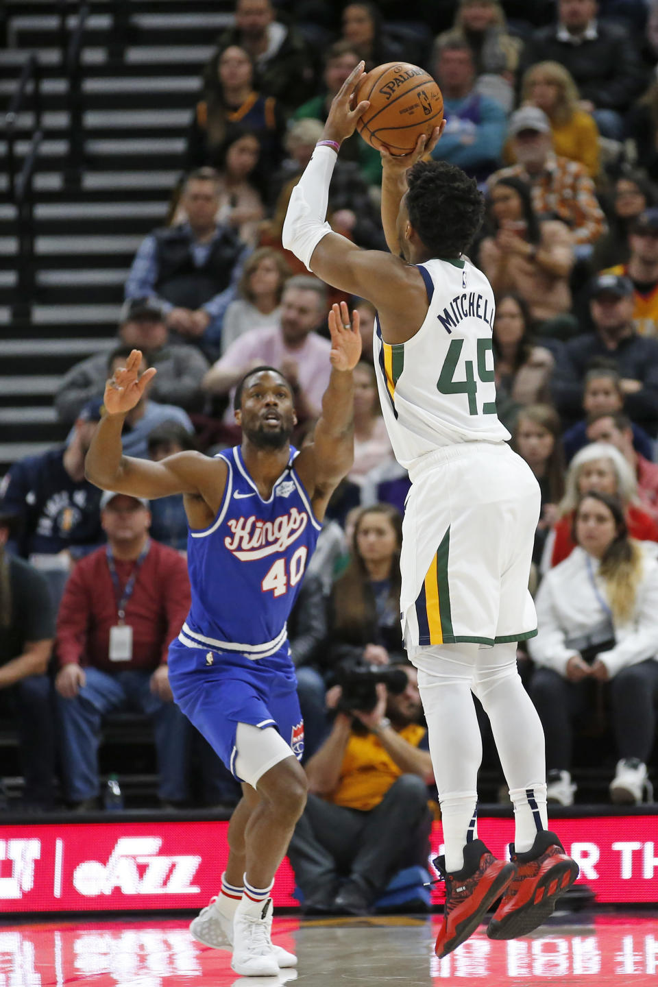 Utah Jazz guard Donovan Mitchell (45) shoots as Sacramento Kings forward Harrison Barnes (40) defends during the first half during an NBA basketball game Saturday, Jan. 18, 2020, in Salt Lake City. (AP Photo/Rick Bowmer)