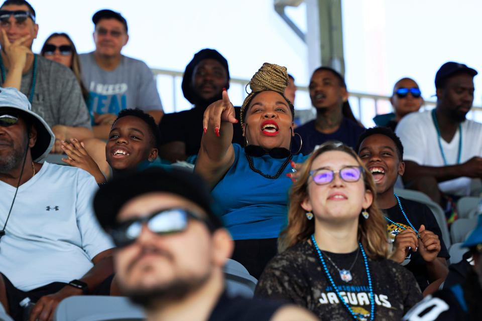 Tiffany Harris (center) points out Jaguars players to her twin sons Jayce Kelly (left) and Gavin Kelly, both 11. They were watching the Jaguars first training camp practice at the Miller Electric Center.