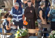 A friar pays his respects as he attends a funeral for the earthquake victims inside a gym in Ascoli Piceno August 27, 2016. REUTERS/Adamo Di Loreto