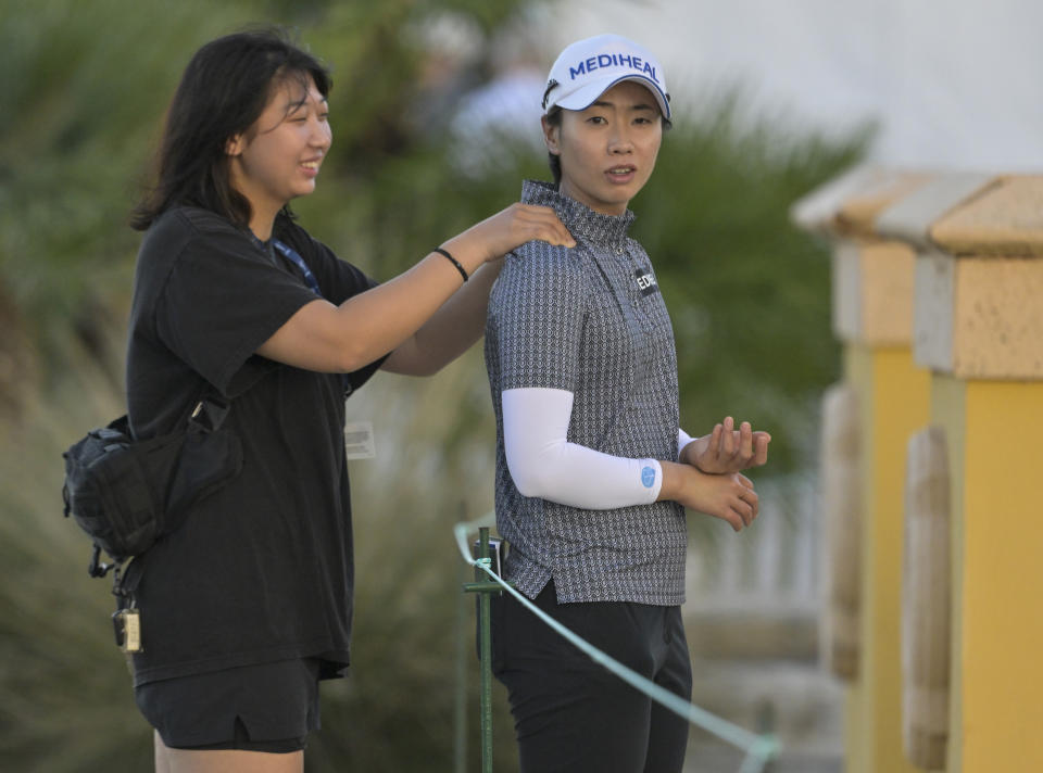 Narin An, right, gets a sholulder rub before teeing off on the first hole during the first round of the LPGA Drive On Championship golf tournament at Bradenton Country Club, Thursday, Jan. 25, 2024, in Bradenton, Fla. (AP Photo/Steve Nesius)