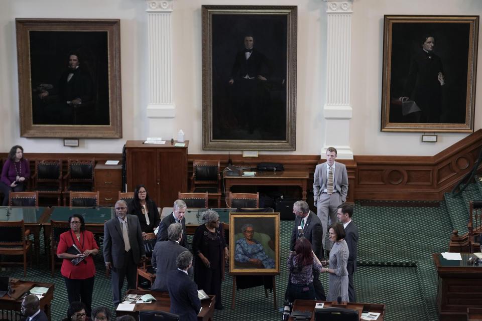 Opal Lee, who worked to help make Juneteenth a federally-recognized holiday, center, stands with her portrait after is was unveiled in the Texas Senate Chamber, Wednesday, Feb. 8, 2023, in Austin, Texas. (AP Photo/Eric Gay)