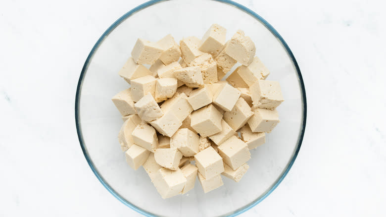 Cubed tofu in mixing bowl
