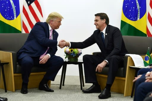 Brazil's President Jair Bolsonaro (R, pictured October 2019) says he has a direct line to US President Donald Trump -- which he may need if Washington reimposes tariffs on his country's steel and aluminum industries