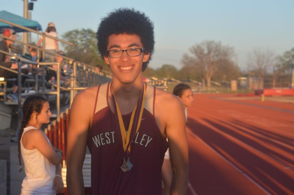 West Valley sprinter Moses Bigelow wears two medals after successful runs at the Eagle Classic Relays at West Valley High School on Wednesday, March 23, 2022.