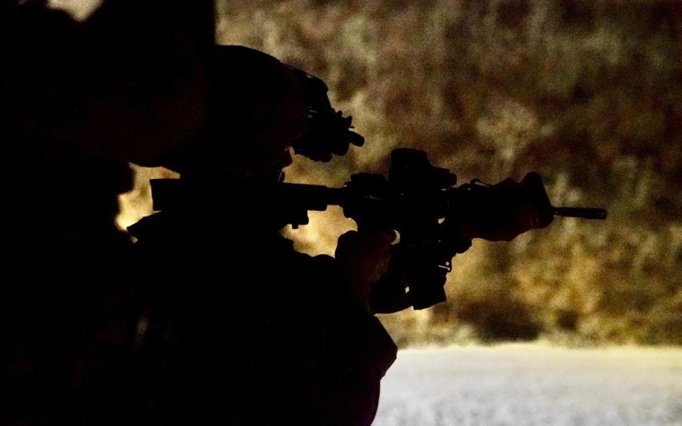 An Israeli soldier holds a firearm during a military action at a location given as Gaza