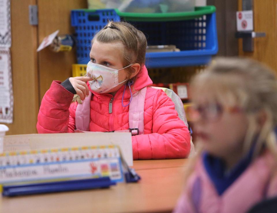 Shelby Orr watches a cartoon before the end of the school day at Tuslaw Elementary School on Friday. Masks are optional for students in the district.