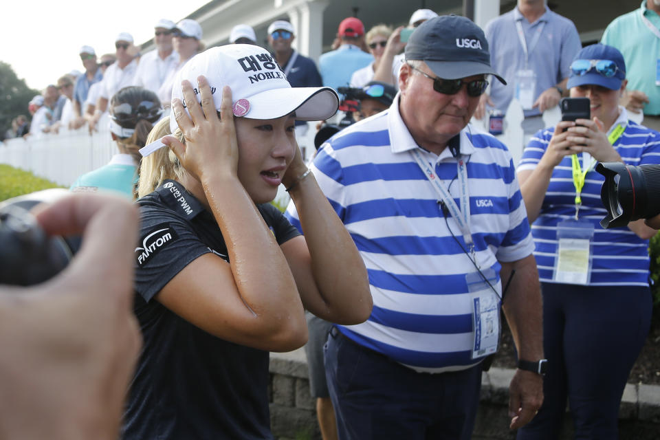 Jeongeun Lee6 of South Korea, reacts to being doused with Champagne after winning the final round of the U.S. Women's Open golf tournament, Sunday, June 2, 2019, in Charleston, S.C. (AP Photo/Steve Helber)