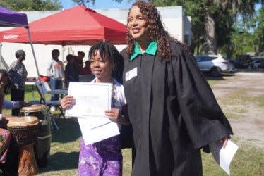 Baylea Carey, left, winner of the Earth Day Essay Contest at Caring and Sharing Learning School and sponsored by the Cultural Arts Coalition, was presented an award by Judge Gloria Walker, right, of the Eighth Judicial Circuit Court of Florida.
(Credit: Photo provided by Voleer Thomas)