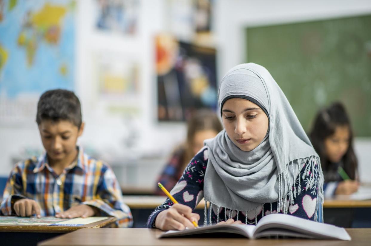 <span class="caption">Several school districts across the country will close in observance of Eid, a holiday that marks the end of Ramadan.</span> <span class="attribution"><a class="link " href="https://www.gettyimages.com/detail/photo/writing-in-a-notebook-royalty-free-image/871328144" rel="nofollow noopener" target="_blank" data-ylk="slk:FatCamera/E+ via Getty Images;elm:context_link;itc:0;sec:content-canvas">FatCamera/E+ via Getty Images</a></span>