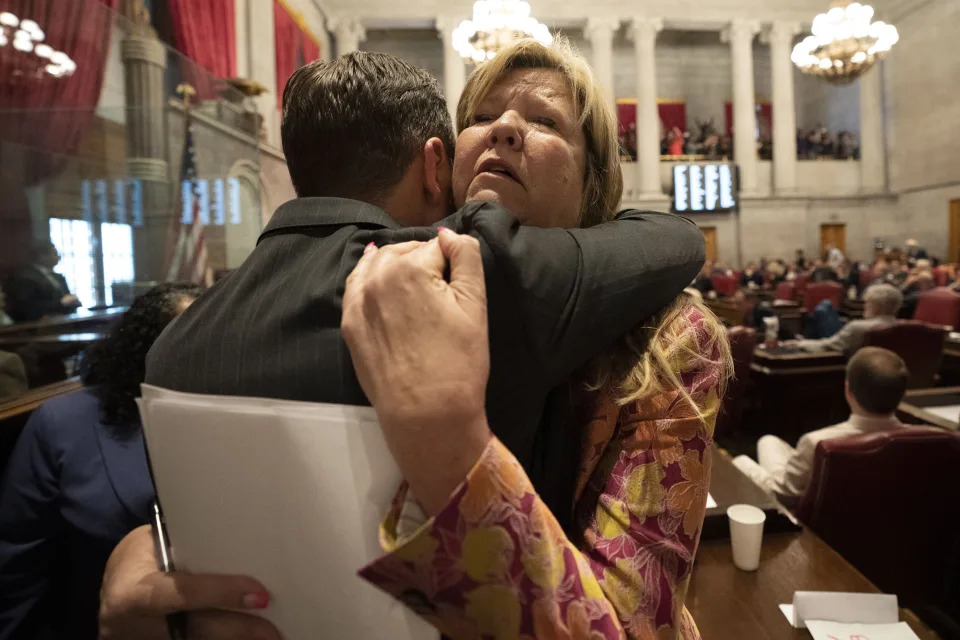 Rep. Gloria Johnson, D-Knoxville, right, receives a hug from Rep. John Ray Clemmons, D-Nashville, on the floor of the House chamber after a resolution to expel Johnson from the legislature failed Thursday, April 6, 2023, in Nashville, Tenn. (AP Photo/George Walker IV)