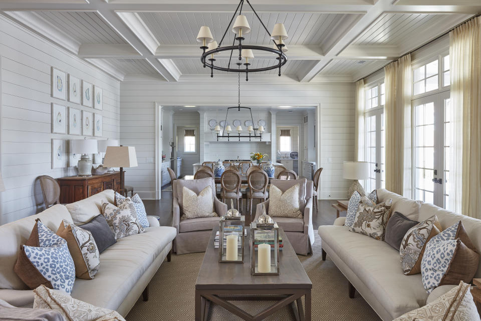 This photo provided by interior designer Maggie Griffin shows a room designed by Griffin. Griffin says homeowners often hang ceiling fixtures too high, especially over dining tables. It's important that they be low enough to illuminate the room and that overhead light is balanced by light from table lamps. (Brian Bieder/Maggie Griffin via AP)