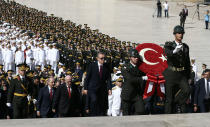 <p>Turkish President Recep Tayyip Erdogan, center, ministers and army commanders follow a guard of honor at the mausoleum of modern Turkey’s founder Mustafa Kemal Ataturk on Victory Day in Ankara, Turkey, Tuesday, Aug. 30, 2016. (AP Photo/Burhan Ozbilici) </p>