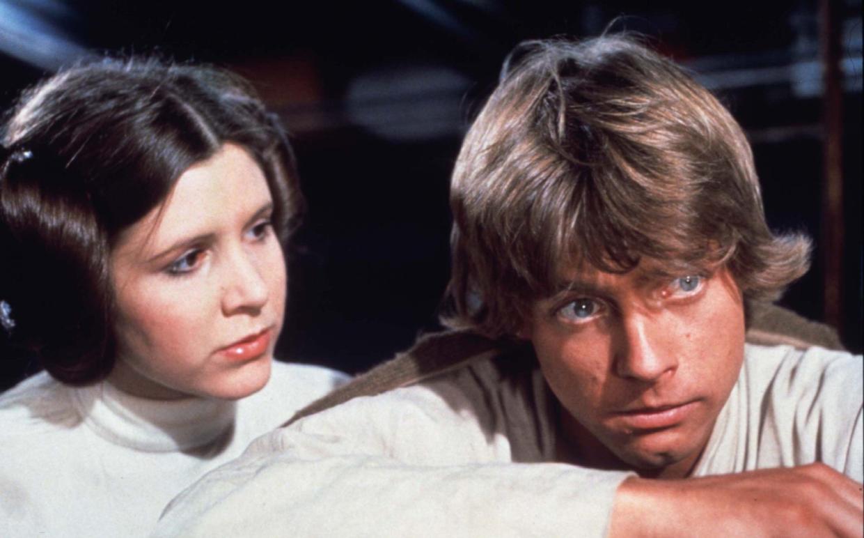 Princess Leia comforts Luke Skywalker after the disappearance of Ben Kenobi in Star Wars