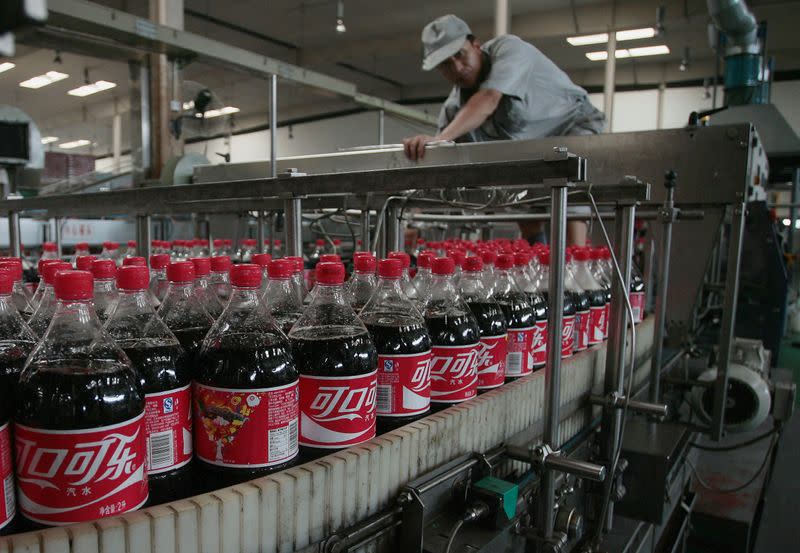FILE PHOTO: An employee works at a production line at the Coca Cola plant in Nanjing