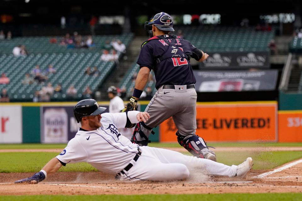 Detroit Tigers outfielder Robbie Grossman scores on a single by Javier Baez as Guardians catcher Luke Maile (12) waits on the throw in the first inning of the Tigers' 4-3 win Thursday night. [Carlos Osorio/Associated Press]