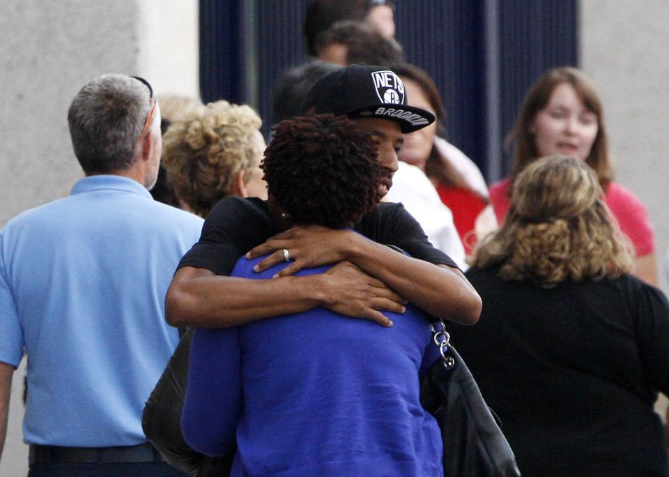 Navy Yard workers evacuated after the shooting are reunited with loved ones at a makeshift Red Cross shelter at the Nationals Park baseball stadium near the affected naval installation in Washington, September 16, 2013. (REUTERS/Jonathan Ernst)