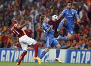 Galatasaray's Didier Drogba (L) challenges Real Madrid's Luka Modric (C) and Alvaro Arbeloa during their Champions League Group B soccer match at Turk Telekom Arena in Istanbul September 17, 2013. REUTERS/Murad Sezer (TURKEY - Tags: SPORT SOCCER)