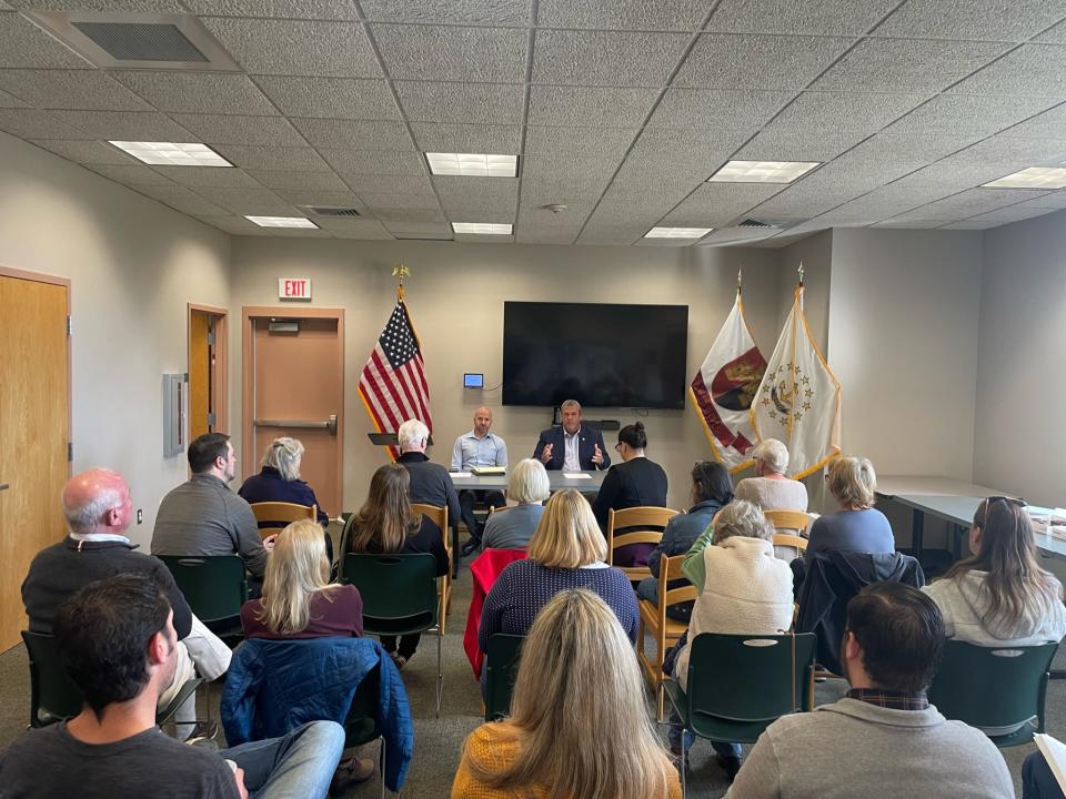 Rob Rock, Rhode Island's deputy secretary of state, (seated at the table to the left) and Rhode Island Secretary of State Gregg M. Amore (seated to the right) talked to residents about election issues this month at the Exeter Public Library in Exeter, Rhode Island.