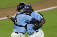 Tampa Bay Rays relief pitcher Diego Castillo, left, and catcher Mike Zunino celebrate their victory against Houston Astros in Game 1 of a baseball American League Championship Series, Sunday, Oct. 11, 2020, in San Diego. The Rays defeated the Astros 2-1 to lead the series 1-0 games. (AP Photo/Ashley Landis)