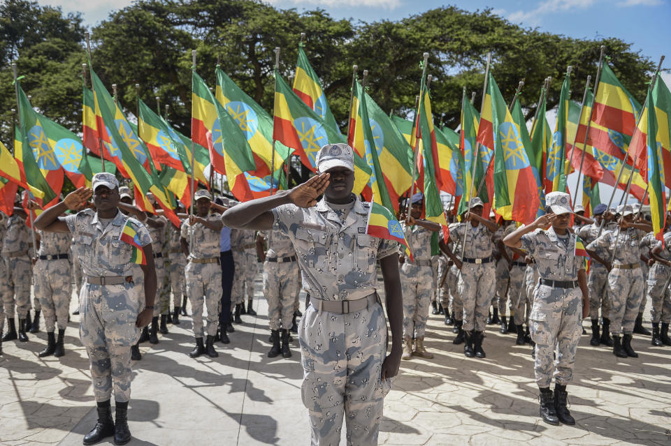 Members of the Ethiopian National Defense Force hold national flags as they parade during a ceremony to remember those soldiers who died on the first day of the Tigray conflict, outside the city administration office in Addis Ababa, Ethiopia Thursday, Nov. 3, 2022. Ethiopia's warring sides agreed Wednesday to a permanent cessation of hostilities in a conflict believed to have killed hundreds of thousands, but enormous challenges lie ahead, including getting all parties to lay down arms or withdraw. (AP Photo)