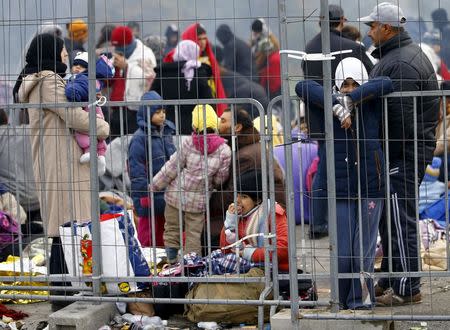 A group of migrants wait to enter a makeshift camp at the Austrian Slovenian border near the village of Sentilj, Slovenia, October 26, 2015. REUTERS/Leonhard Foeger REUTERS