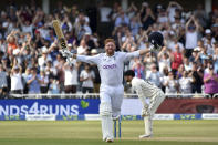 England's Jonny Bairstow raises his bat and helmet to celebrate scoring a century during the fifth day of the second cricket test match between England and New Zealand at Trent Bridge in Nottingham, England, Tuesday, June 14, 2022. (AP Photo/Rui Vieira)