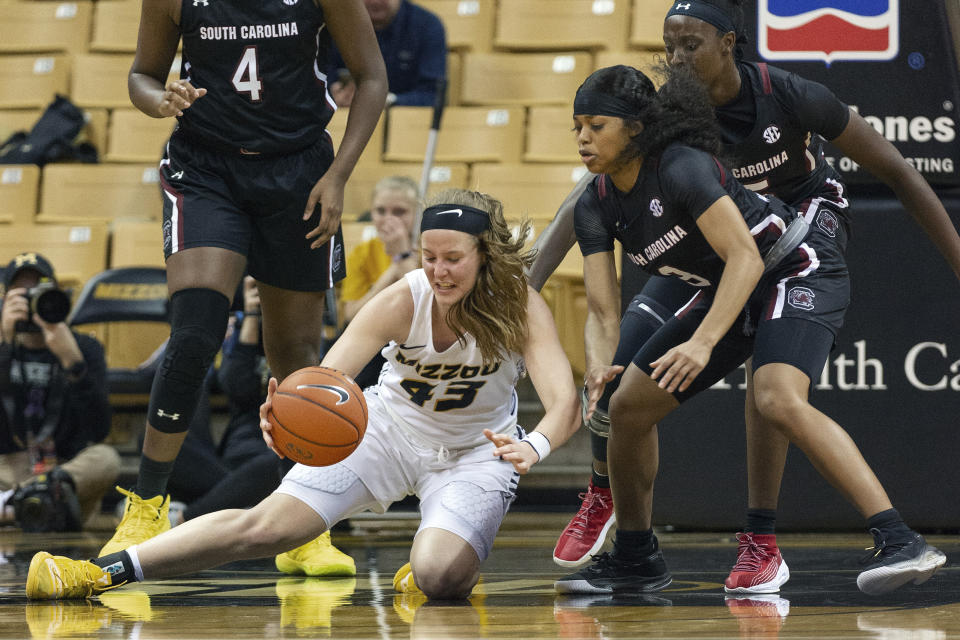 Missouri's Hayley Frank, left, picks up a loose ball in front of South Carolina's Destanni Henderson, right, during the first half of an NCAA college basketball game Thursday, Jan. 16, 2020, in Columbia, Mo. (AP Photo/L.G. Patterson)