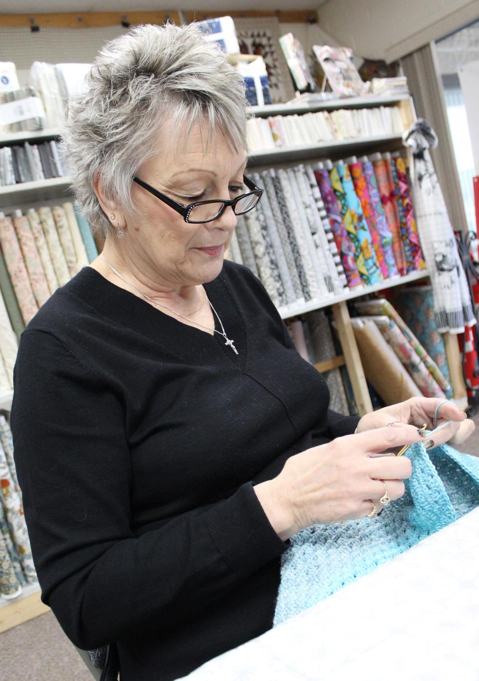 Lori Bully of Woodhaven crochets a blanket at Knit-Picky & Hooked, 15555 S. Telegraph Road.