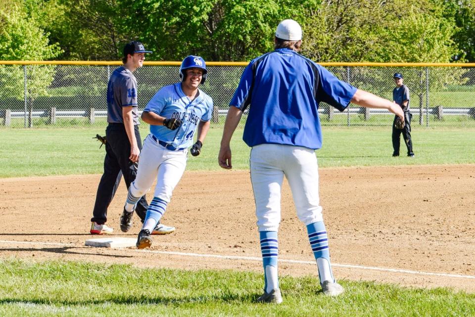 Andrew Grover gets congratulated after hitting a home run during Colo-NESCO's 6-4 victory over Collins-Maxwell Friday at Collins.
