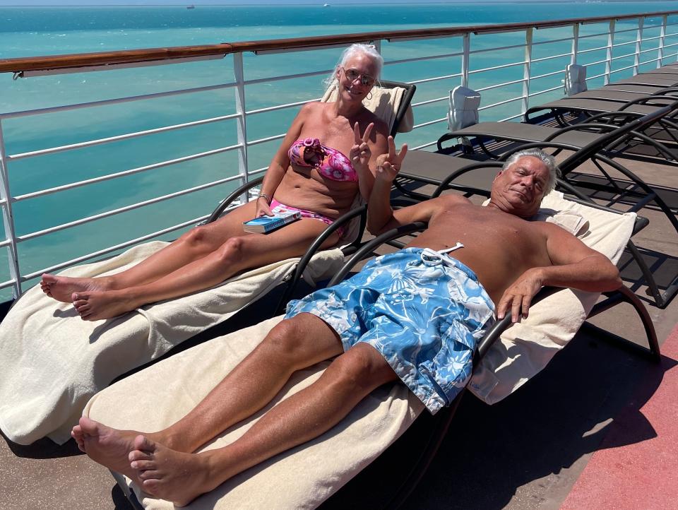 The writer and husband sunbathe on cruise ship