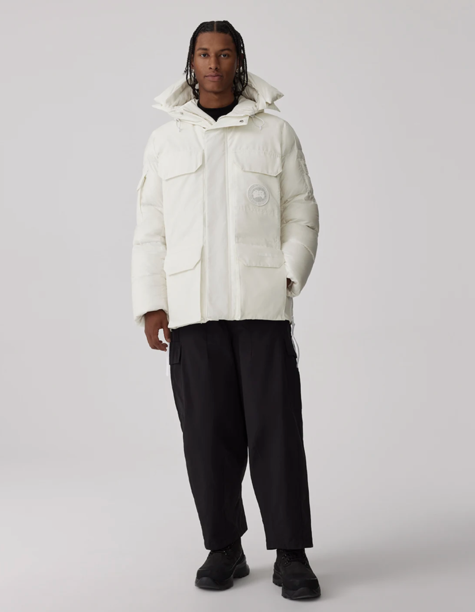 man wearing black pants and white winter jacket, Paradigm Expedition Parka