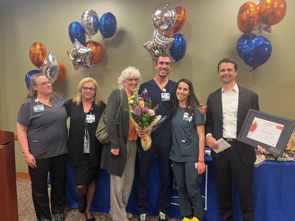 ICU nurse Graham Phelps, RN, of Durham is the recipient of the 2022 Nursing Excellence – Compassionate Care Award at Portsmouth Regional Hospital. Pictured from left, ICU nurse Trish Yaxley, RN; Nancy Seskes, RN, associate chief nursing officer; Graham’s mother Ruth Abelmann; Graham, and his wife Jody Domsky; and Dean Carucci, market president, HCA New England Healthcare, and CEO of Portsmouth Regional Hospital.