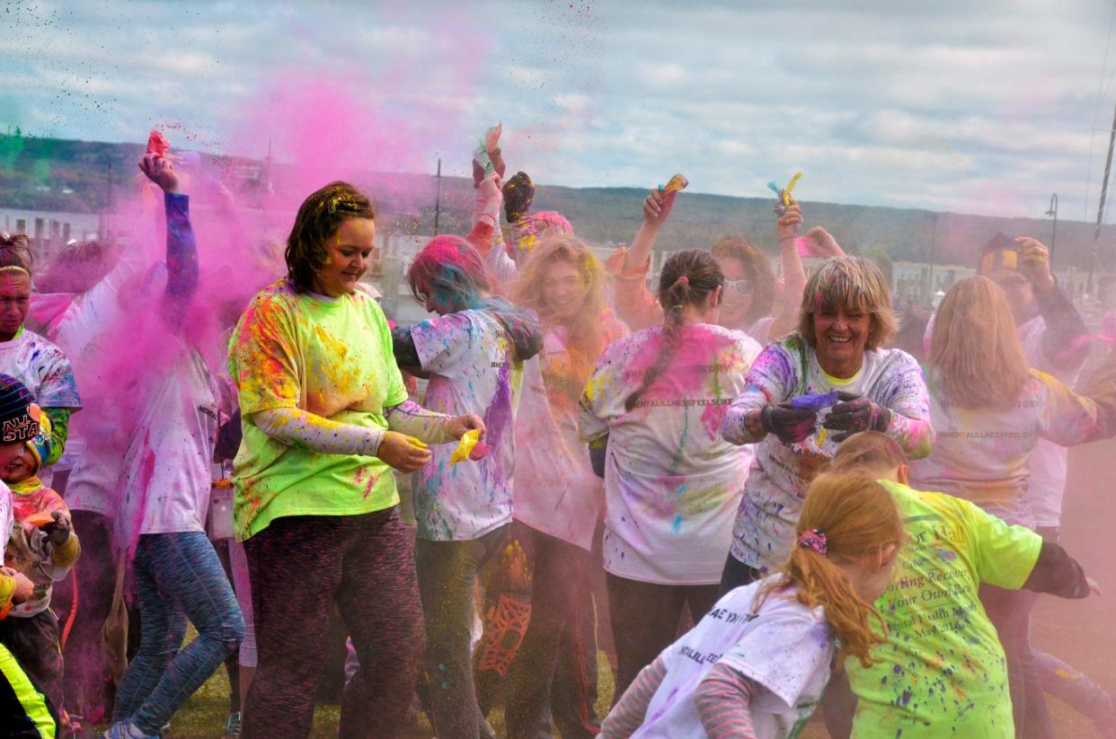 A rainbow of color fills the air as a free for all breaks out during the end of the race celebration at the 19th annual North Country Community Mental Health "Splash of Color" 5K Fun Run and Mile Walk.