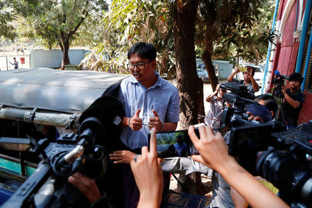 Detained Reuters journalist Wa Lone talks to reporters as he leaves after a court hearing in Yangon, Myanmar February 14, 2018. REUTERS/Stringer