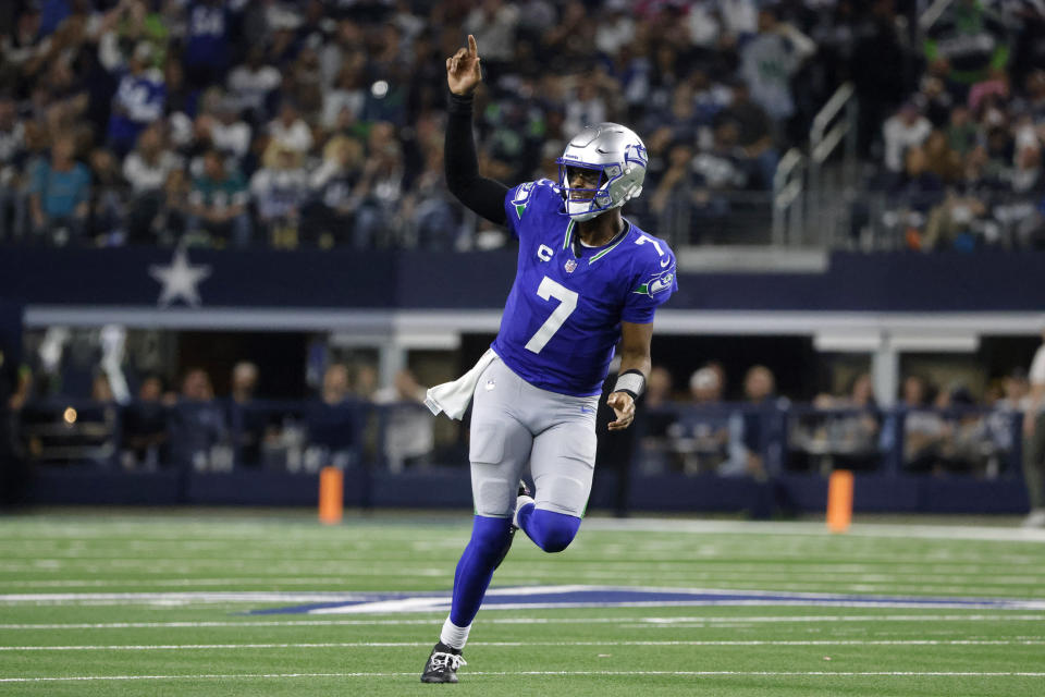 Seattle Seahawks quarterback Geno Smith celebrates after throwing a touchdown pass to wide receiver DK Metcalf in the second half of an NFL football game against the Dallas Cowboys in Arlington, Texas, Thursday, Nov. 30, 2023. (AP Photo/Michael Ainsworth)