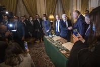 Israeli Foreign Minister Yair Lapid, presents Egyptian Foreign Minister Sameh Shoukry with stolen Egyptian artifacts that were smuggled to Israel and returned back to Egypt, at Tahrir Palace in Cairo, Egypt, Thursday, Dec. 9, 2021. (AP Photo/Nariman El-Mofty)