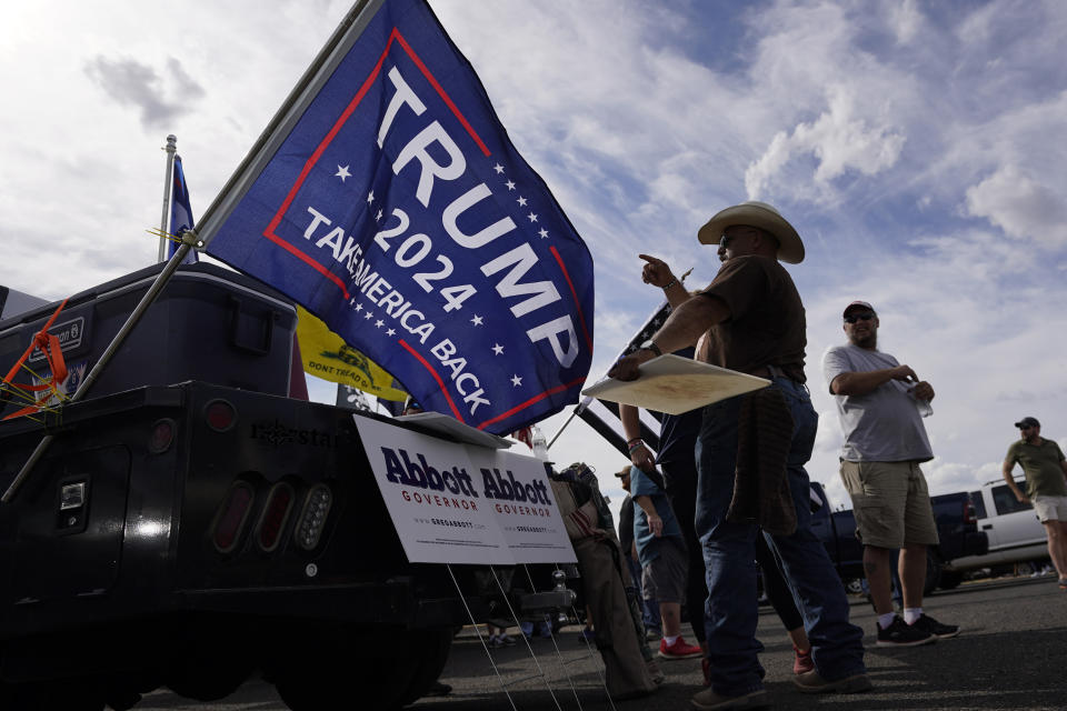 Abel Salazar and other supporters of Texas Gov. Greg Abbott gather near an event for Democratic candidate Beto O'Rourke, Wednesday, Aug. 17, 2022, in Fredericksburg, Texas. On the brink of November's midterm elections, both full-time election workers in rural Gillespie County suddenly and stunningly quit this month with less than 70 days before voters start casting ballots. (AP Photo/Eric Gay)